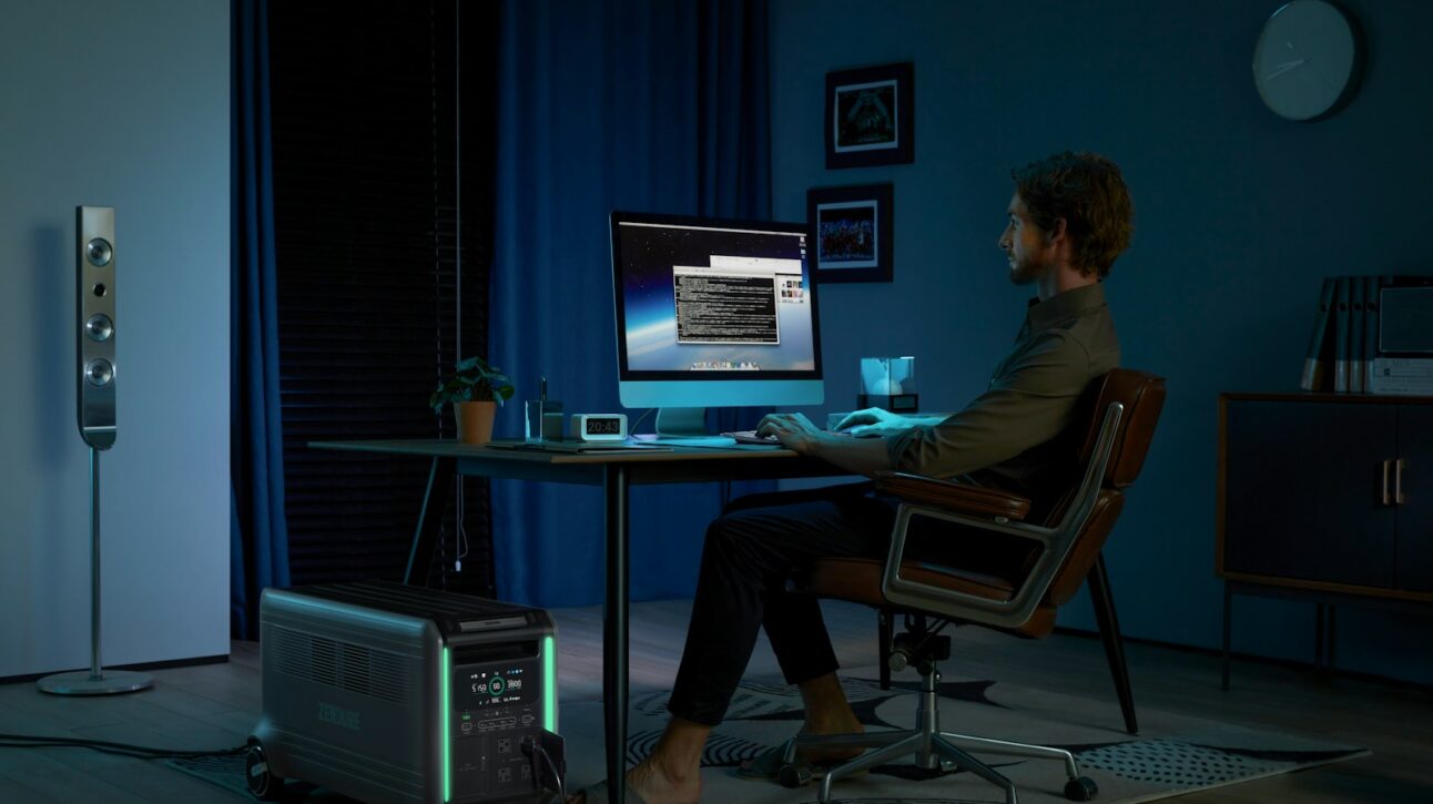 a man sitting at a desk in front of a computer