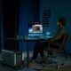 a man sitting at a desk in front of a computer