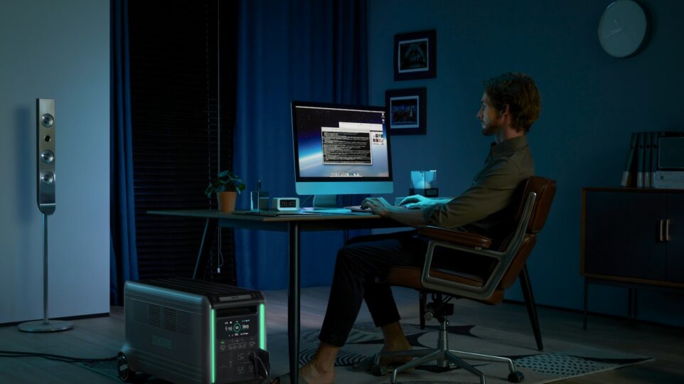 a man sitting at a desk in front of a computer